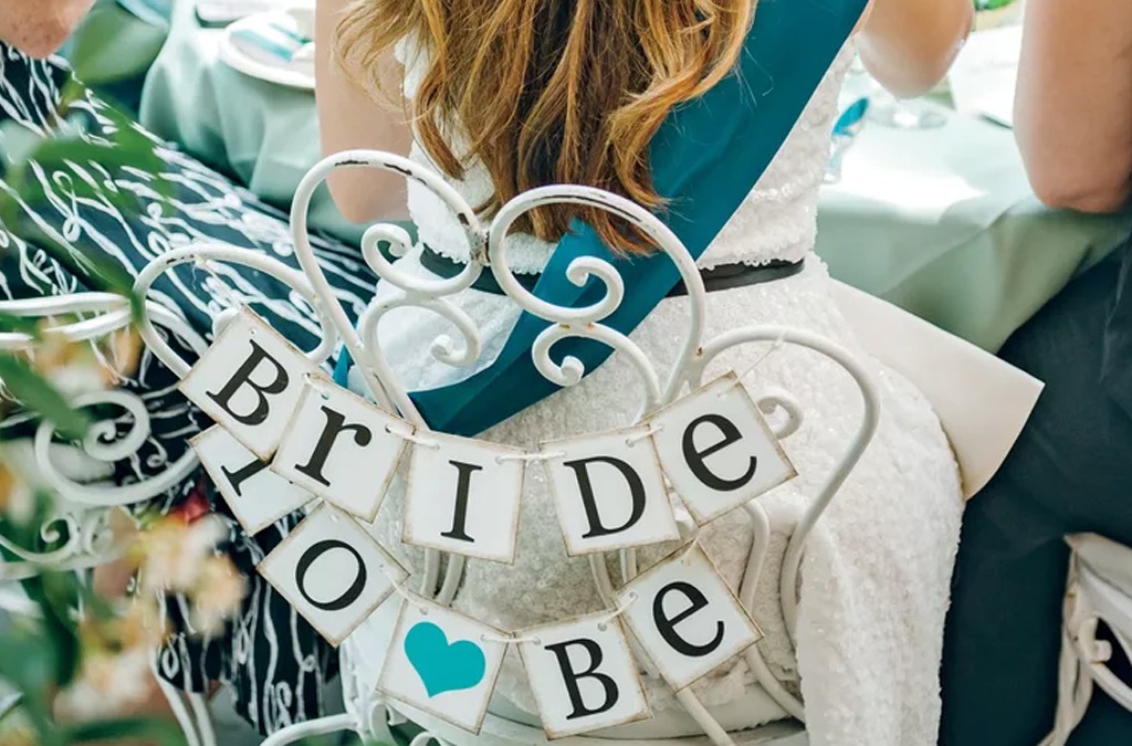 Bridal shower with bride to be banner on chair