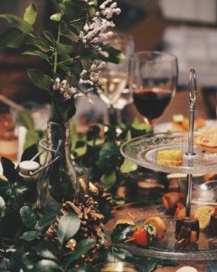 holiday party table wine glasses and tiered dessert plate