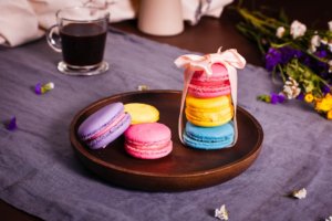 stack of three delicate, colorful macarons tied with a ribbon