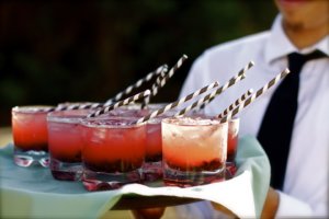 a party tray of cocktails with straws 