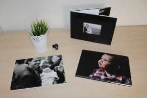 Personal photographs of milestones on a table.