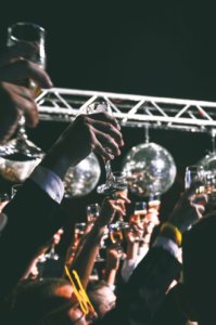 Several champagne glasses raised for a toast at a wedding.