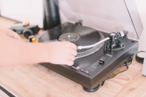 hand moving needle on record turntable