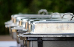several chafing dishes lined up for a wedding buffet 