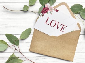 envelop containing a wedding invitation that says Love