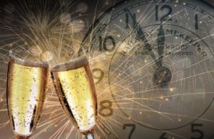 two champagne glasses, fireworks, and a clock