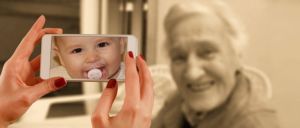 Picture of baby on cell phone and old woman
