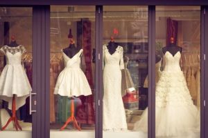 Four wedding dresses in a storefront window