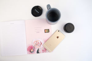 cell phone and flower notebook wedding planning