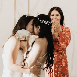Two brides kissing on their wedding day