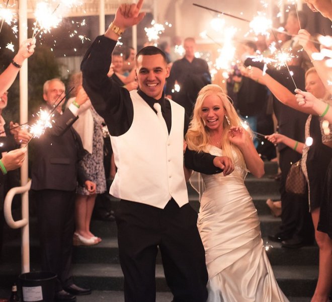 bride and groom celebrating wedding surrounded by sparklers at Pinecrest Country Club in Montgomery County PA 