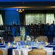 wedding centerpieces and table settings under blue uplighting at Pinecrest Country Club, a wedding venue in Lansdale PA 