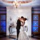 bride and groom under an elegant chandelier at Pinecrest Country Club, a wedding venue near Philadelphia