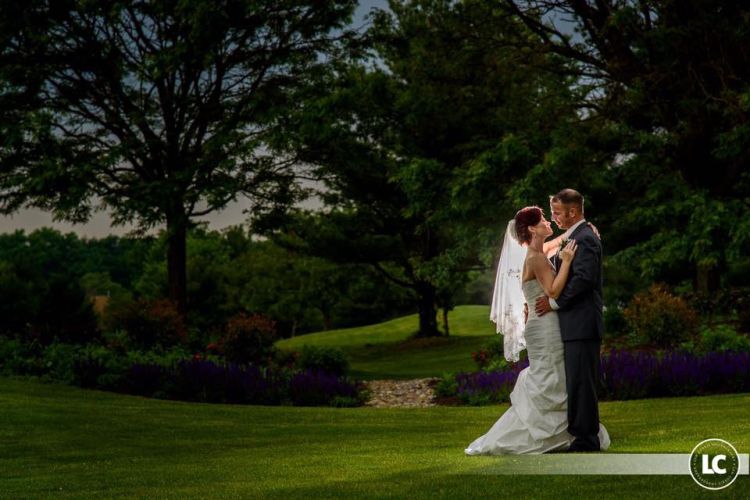 wedding couple poses on the golf course at Pinecrest Country Club a wedding party space near Bucks County PA 