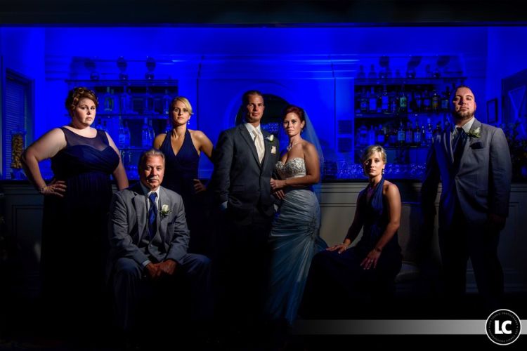bridal party posed in front of a bar at Pinecrest Country Club, a wedding venue and party space near Bucks County PA