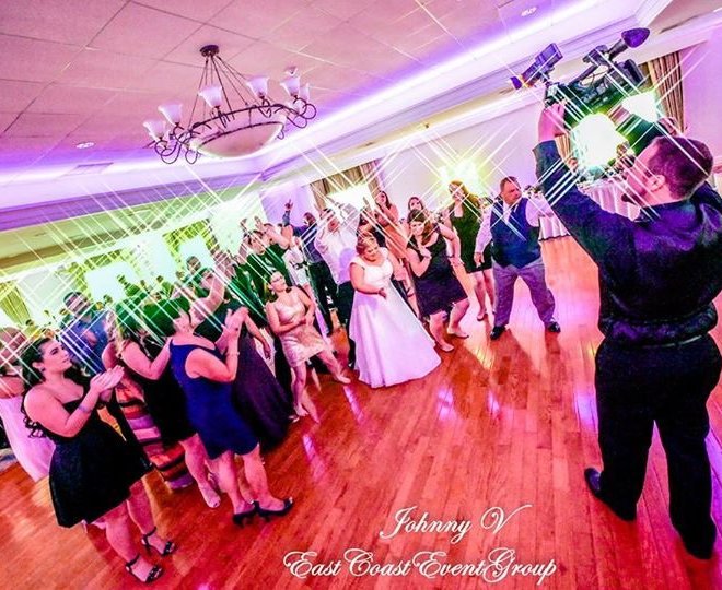 Pinecrest Country Club wedding guests dancing with the bride at a party space near Bucks County