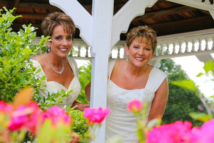Two brides taking a photo in the gazebo at PineCrest Country Club in Montgomery County, PA