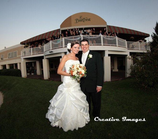 Wedding couple standing on the PineCrest golf course in front of the elegant deck in Montgomery County