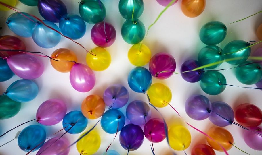 party space decorated with balloons for a milestone celebration