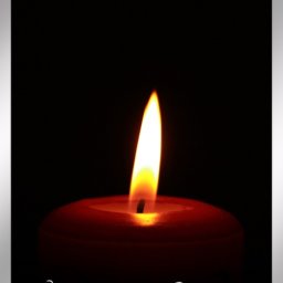 Single lit candle with text that reads In Loving Memory