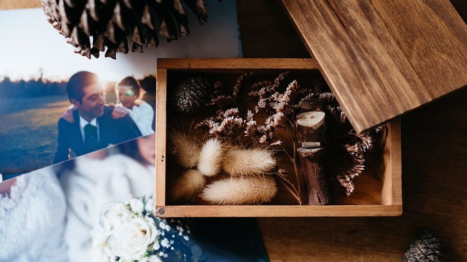 Photograph of a wedding couple on a table with other decorative memory box items