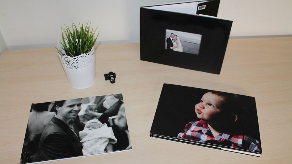 Personal photographs of milestones on a table.