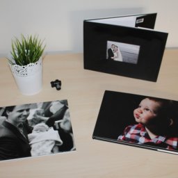 Personal photographs of milestones on a table.