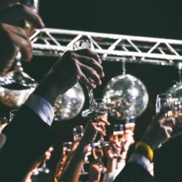 Several champagne glasses raised for a toast at a wedding.