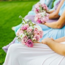 bridesmaids sitting down with flowers in their laps