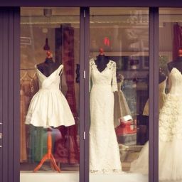 Four wedding dresses in a storefront window