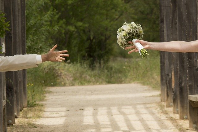 wedding couple reaching out to one another's hands