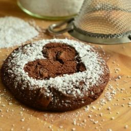 single cookie pastry with a heart imprint and powdered sugar