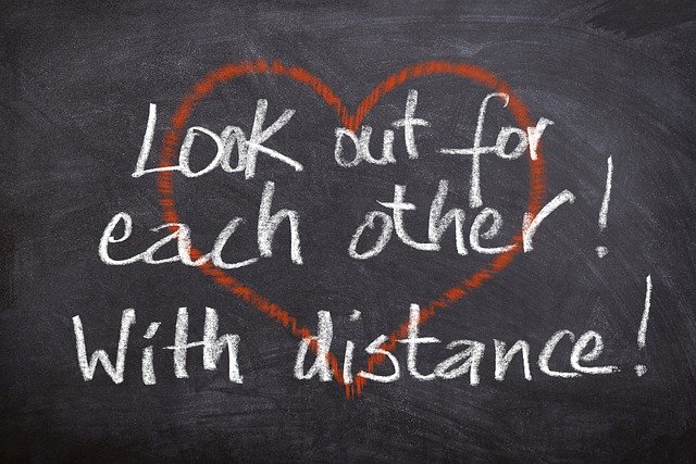 Written in Chalk "Look out for each other! with Distance!"