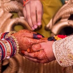 Bride and groom holding hands at an Indian wedding