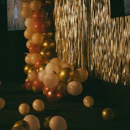 Room decorated with gold tinsel and balloons