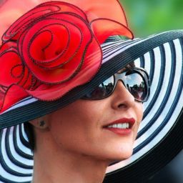 Woman in a black and white hat with red fabric accent