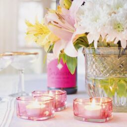 White flowers, glasses and candles on a table
