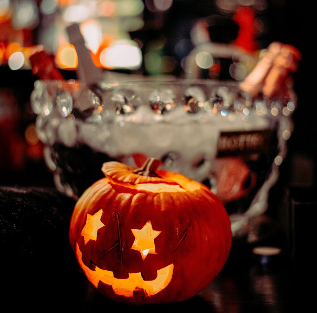 Halloween themed party with a carved pumpkin and drinks