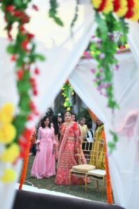 White curtains and flowers framing the Bride of a Traditional Indian Wedding