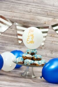 donut cake with best day ever balloon on top