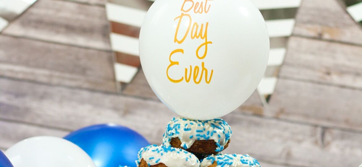 donut cake with best day ever balloon on top