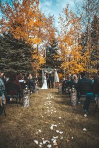 A couple getting married outdoors in autumn