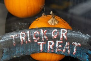 Pumpkins with a sign that says “Trick or Treat”