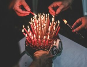 60th birthday cake with 60 lit candles