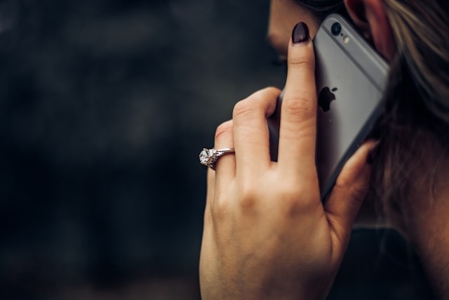 Woman wearing an engagement ring while on the phone