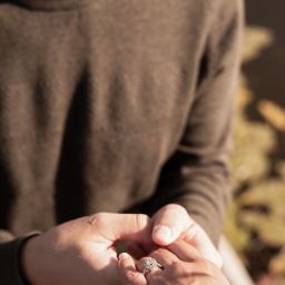 A man holding a women’s hand with a ring after proposing